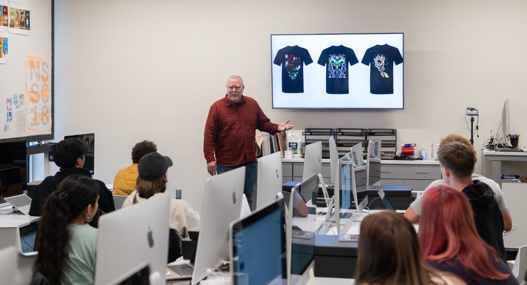 Professor John Decker giving instruction to a group of students
